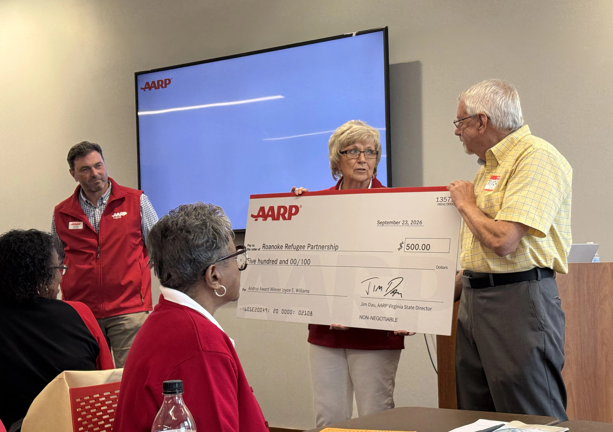 Joyce Williams recieving check for Roanoke Refugee Partnership