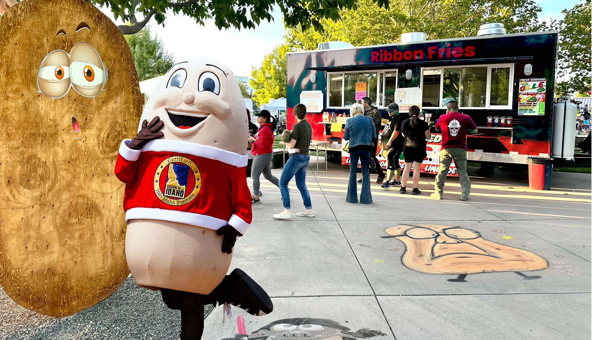Colorful Fall Fests a person in an idaho potato costume standing in front of a food truck