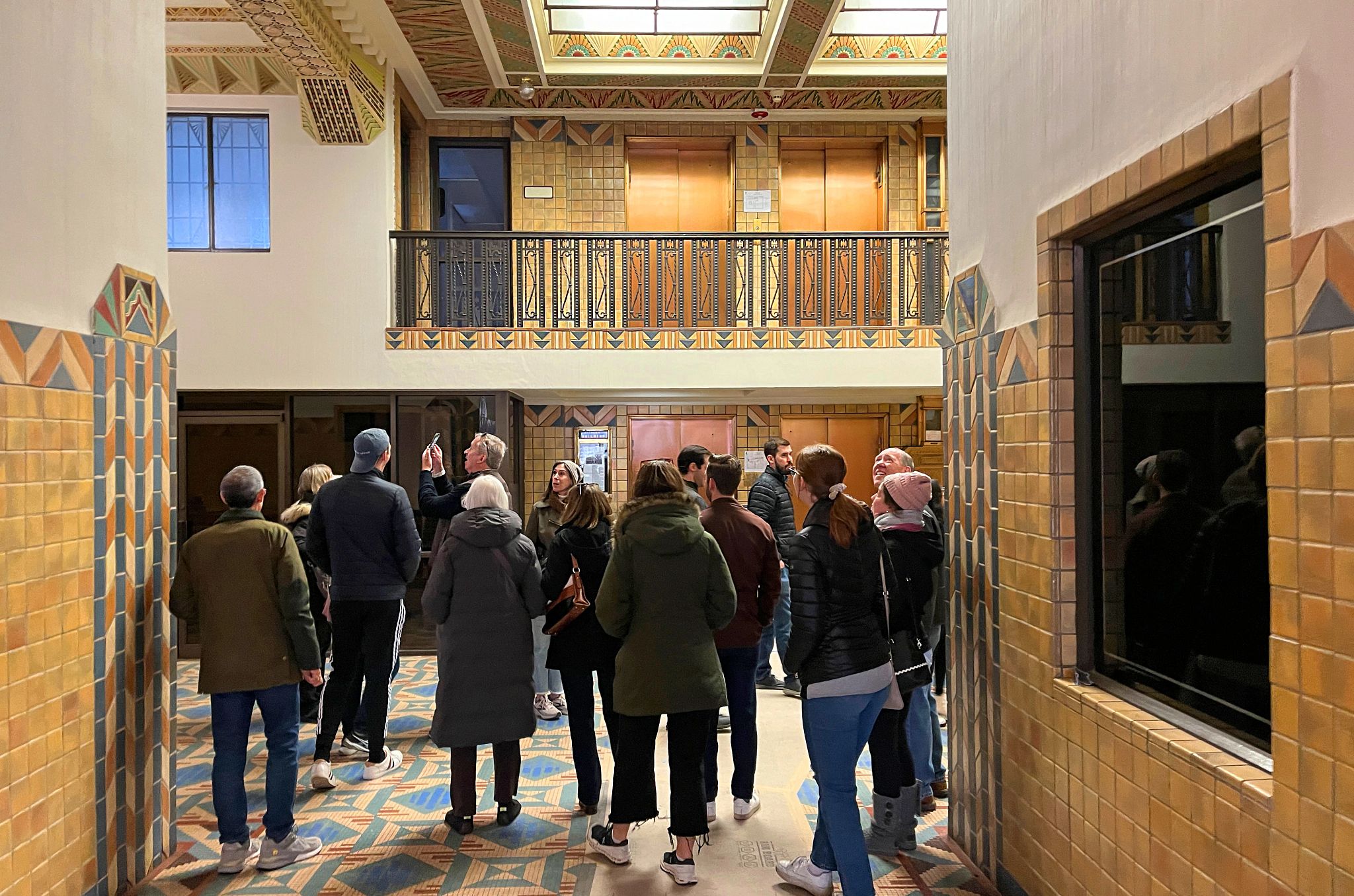 Pythian Building people standing together in a room with art deco architecture
