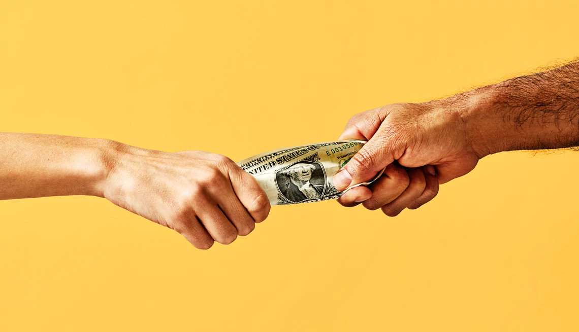 two hands exchanging dollars