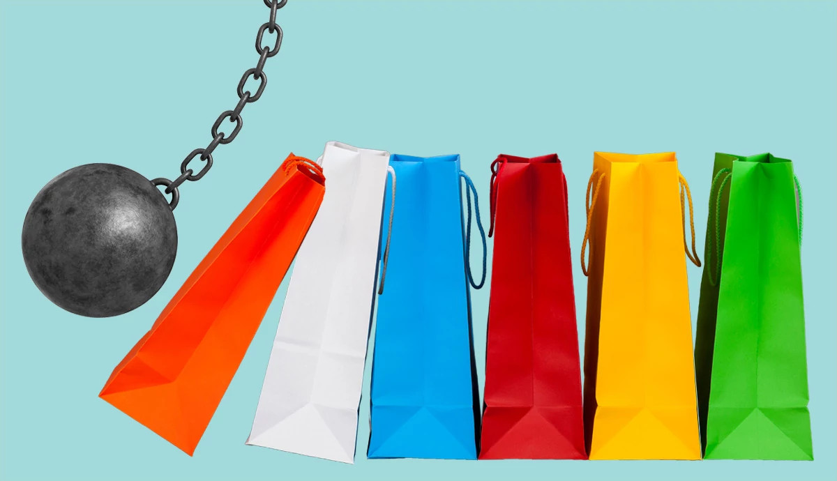 a wreaking ball knocks over different color shopping bags