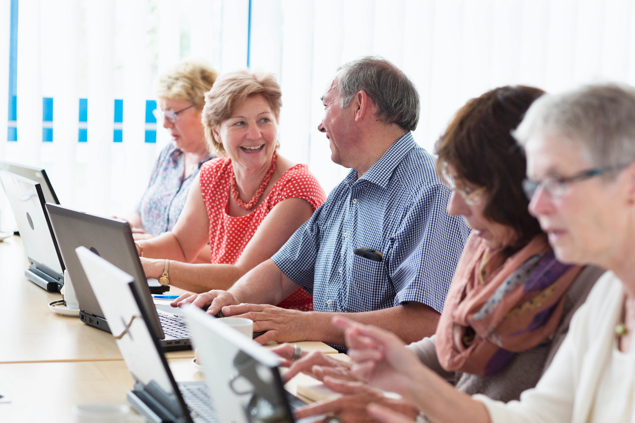 senior adults learning in computer lab