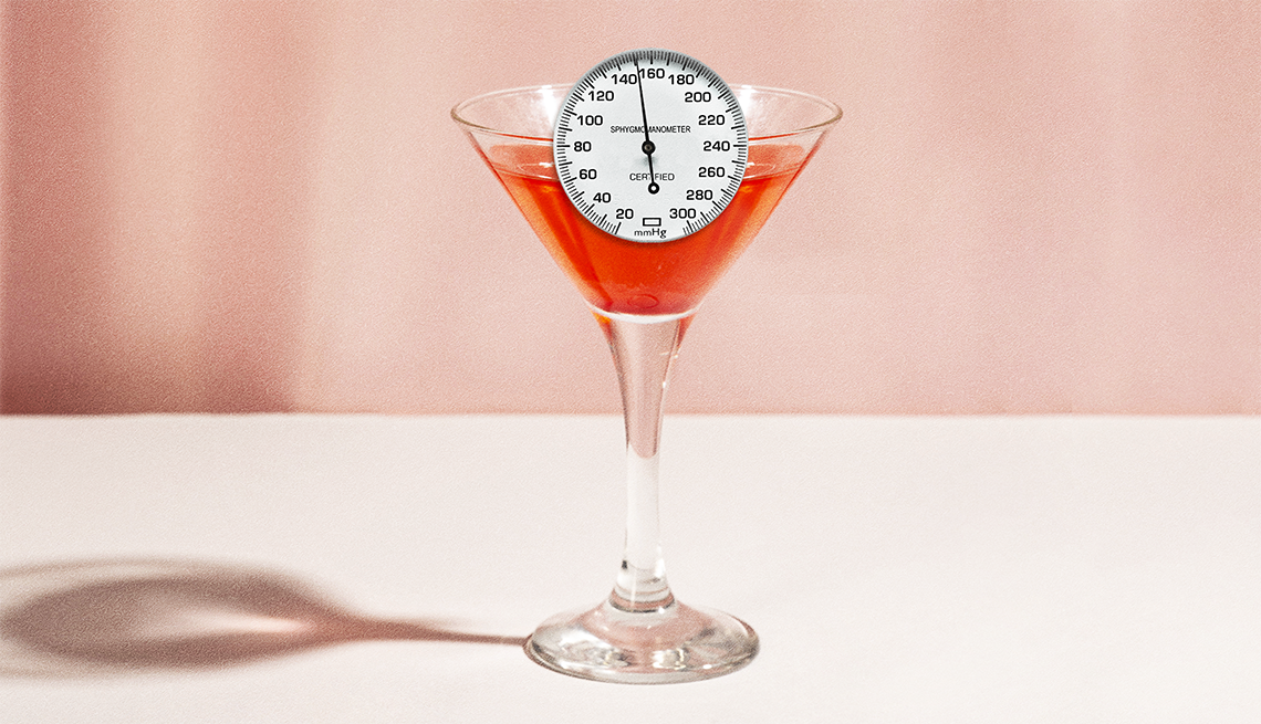 Even modest amounts of alcohol can contribute to high blood pressure. a blood pressure gauge sitting in a cocktail glass