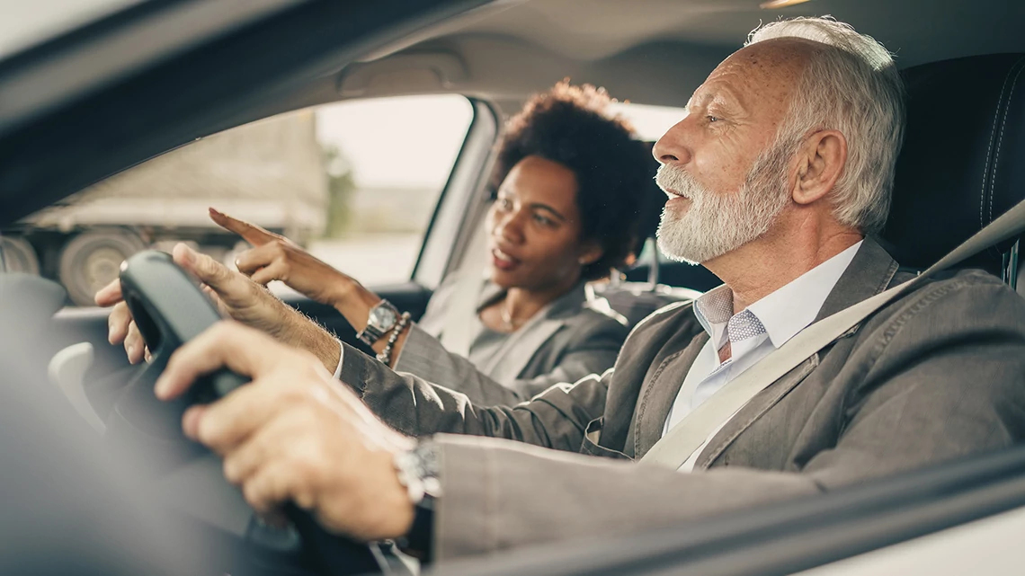 Avis Car Rentals Shot of two successful multi-ethnic business people during morning commute.