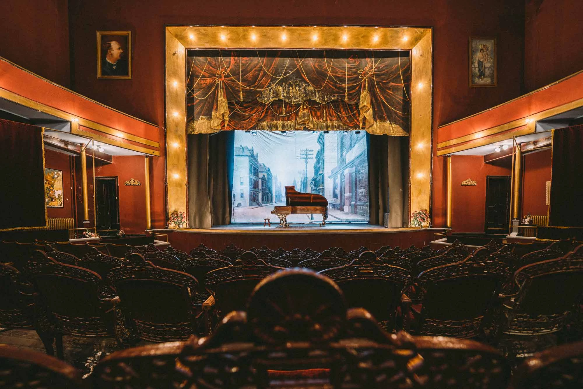 a piano sits on the stage of an opera house