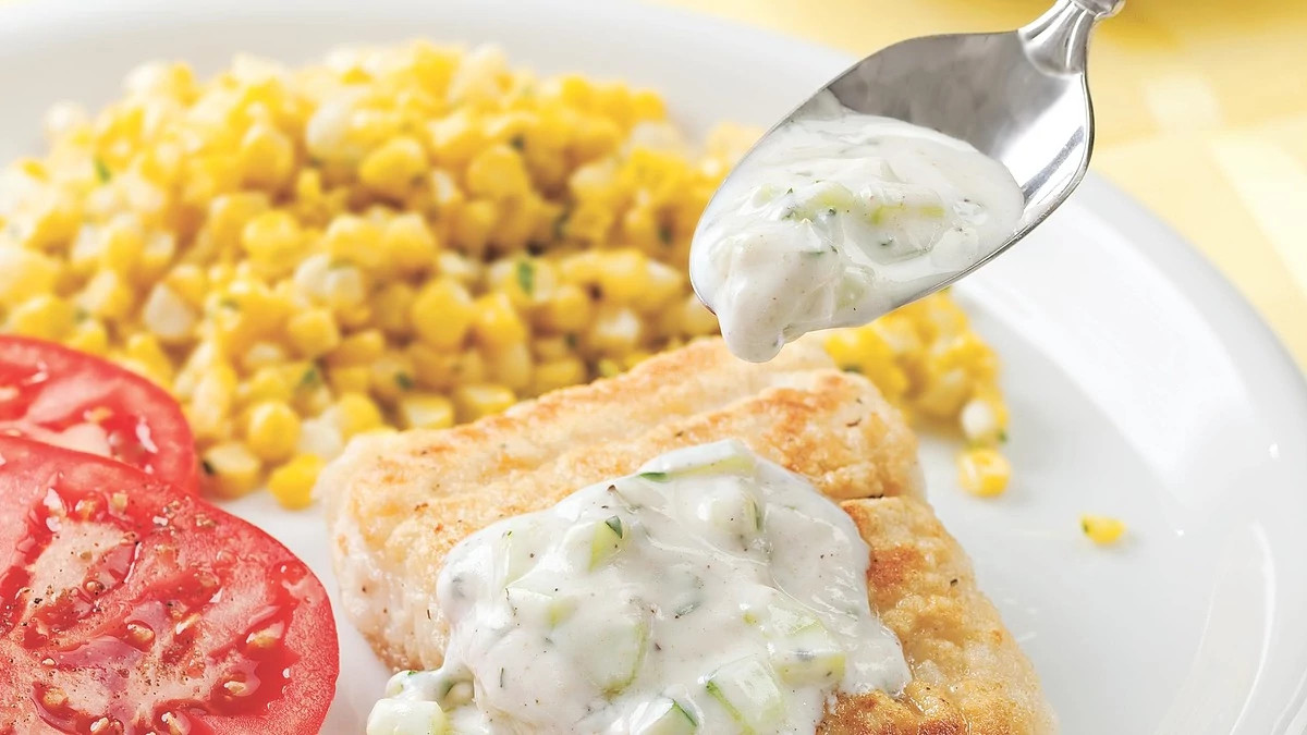 A close-up view of fish fillets with cucumber raita