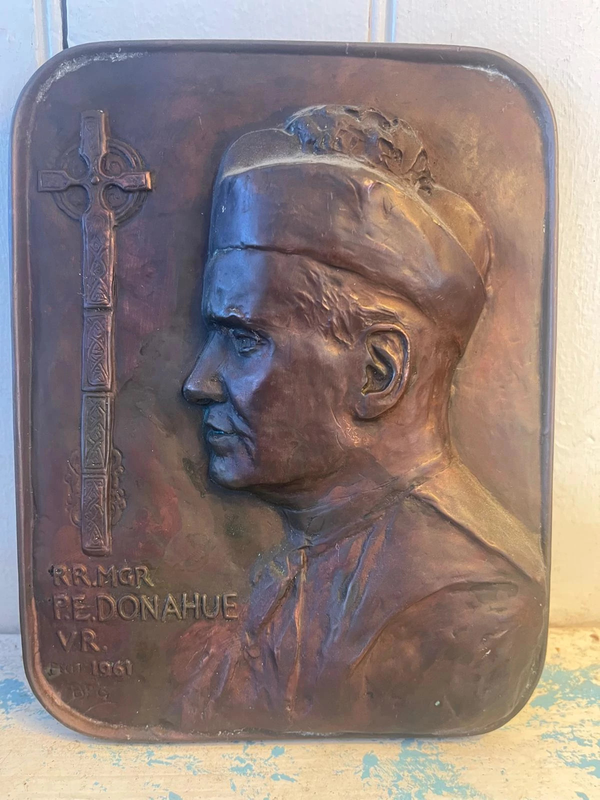 a photo shows a plaque marking the day of his promotion from priest to monsignor