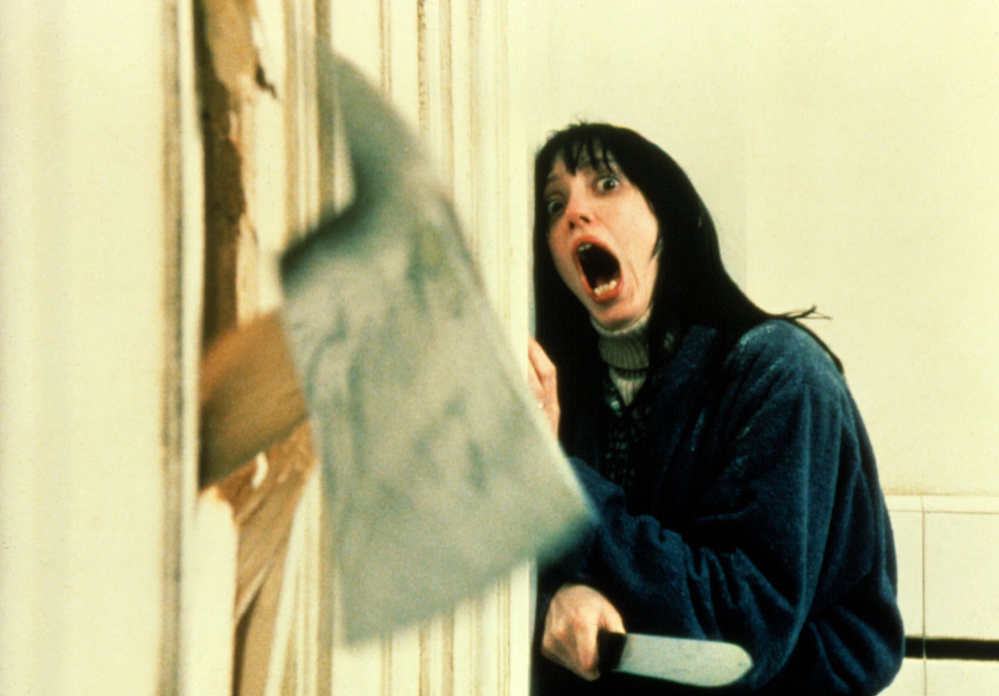 Shelley Duvall in The Shining Shelley Duvall screams as an ax goes through a door in the film The Shining