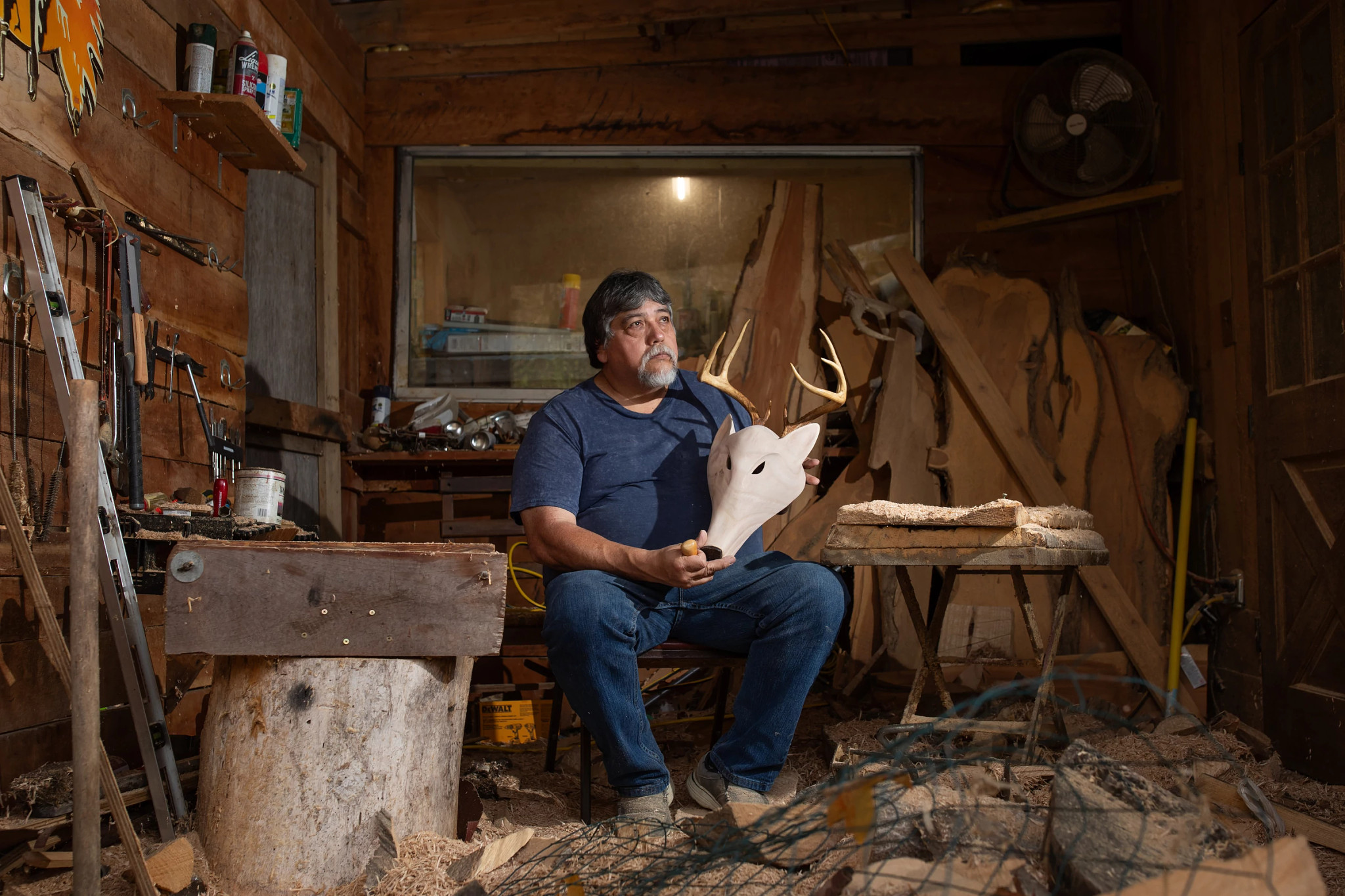 a man holding a skull with horns