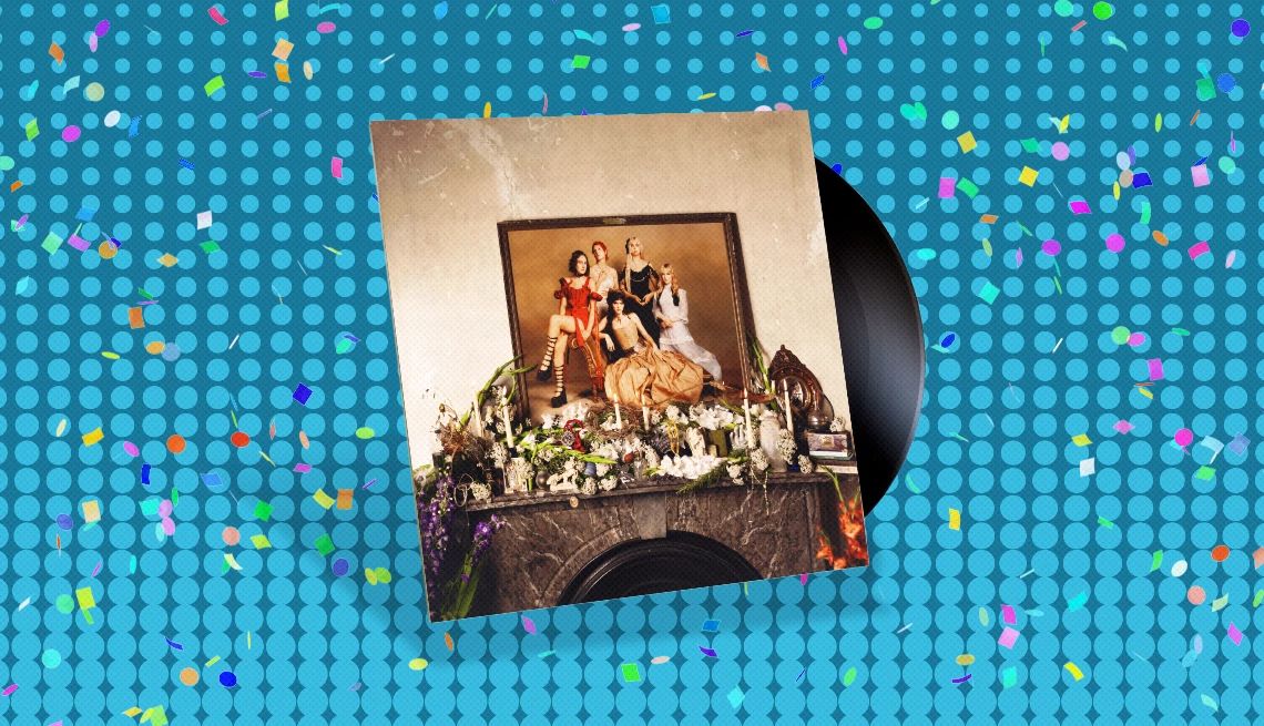 The Last Dinner Party's “Prelude to Ecstasy” Album cover with record sticking out of it and five people in picture frame on cover; blue background with confetti on it