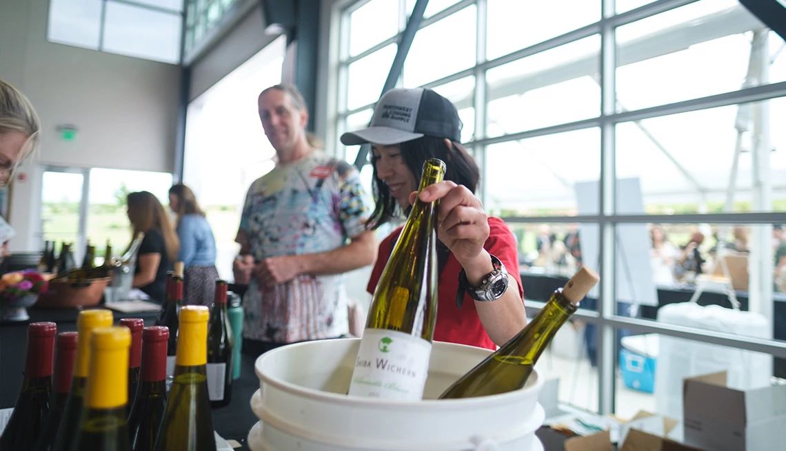 Wine event woman holds bottle of wine during event