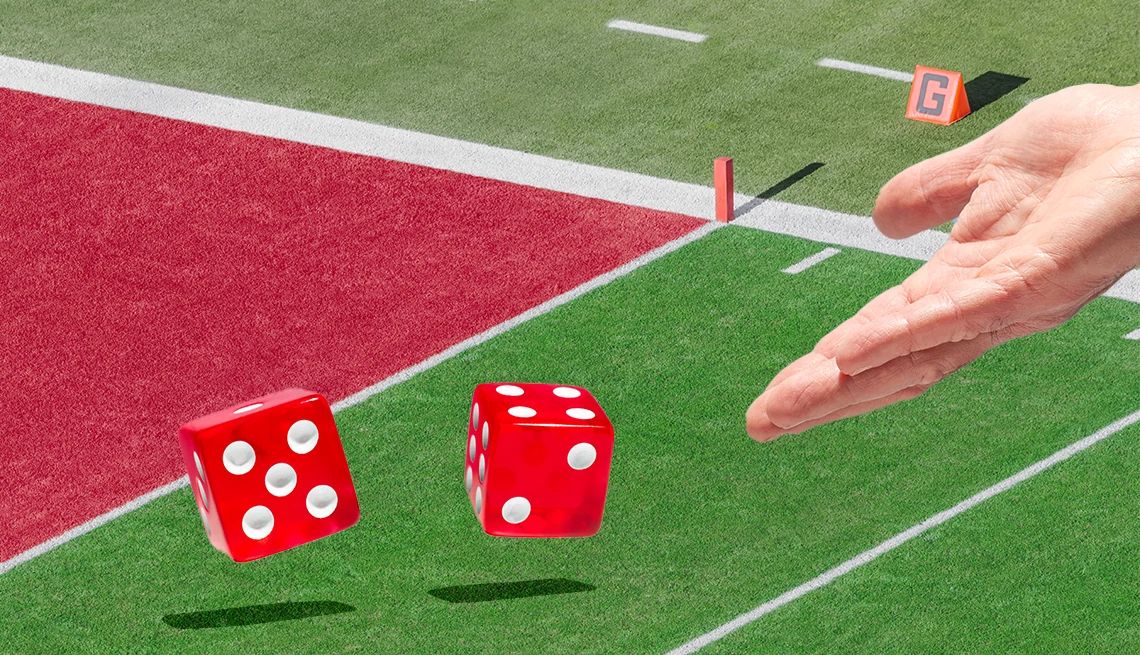 Scammers Are Drawn to Online Sports Betting a hand rolling red dice across a sports field